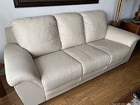 Front view of the three-seat ivory leather couch