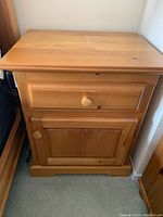 Front view of pine night stand with drawer and cabinet closed