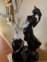 Overall view of the black lacquered lady statue and vase, showing size and finish.