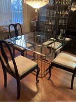 Full set showing black lacquered dining table with glass top and four chairs