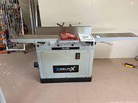 Front view showing infeed and outfeed cast iron tables with fence