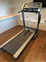 Angled front view of Pacemaster treadmill showing running deck, side rails and console.