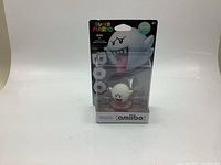 Front view of the sealed Super Mario Boo amiibo figure in original packaging showing character and branding.