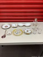 Overview of all items on table showing plate, dishes, glasses, serving utensil, and decanter.