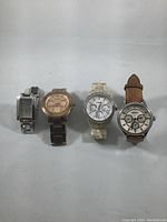 Four ladies Fossil watches shown side by side on a light surface, displaying different styles and bands.