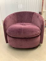 Front view of the purple swivel tub chair showing plush seat cushion and rounded backrest.
