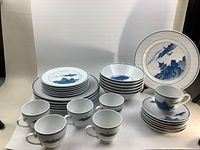 Photo showing the full set laid out with plates, bowls, cups, and saucers grouped.