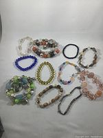 Overview of all 11 vintage costume jewelry bracelets with various bead compositions and colors.