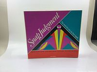 Front of the Snap Judgment vintage law board game box with geometric colorful design.