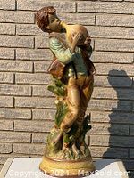 Front view of large Italian ceramic statue of boy holding jug