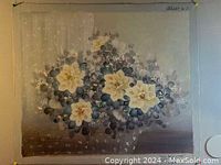 Full view of the oil on canvas floral painting showing cream flowers and darker leaves on muted background.