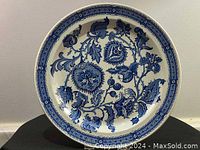 Front view of the blue and white vintage ironstone plate showing the full floral design and overall condition.