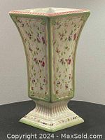 Front view of vintage floral chintz vase showing tapered square shape and floral design.