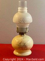 Full view of vintage hand painted glass oil lamp showing the overall shape, frosted glass chimney, and floral details on the base.