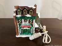 Front and side view showing the building's details and light with power cord.