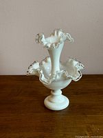Front view of the vintage Fenton single horn Silver Crest epergne showing the clear ruffled edges and central elongated horn.