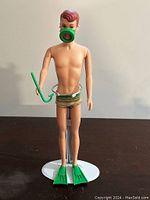 Front view of 1963 Allen doll standing upright, wearing the complete Ken outfit with snorkel mask, snorkel, swim trunks, and fins.
