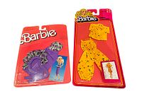Two vintage Barbie Superstar Era outfits sealed in original red blister card packaging side by side.