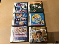 Photo of six Nintendo DS game cases arranged in two columns with clear visible titles and cover art.