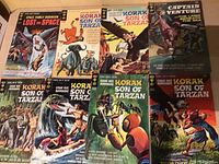 Photo showing front covers of 8 vintage Gold Key comics including multiple Korak Son of Tarzan issues and Lost in Space.