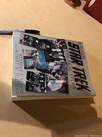 Image showing a paperback book titled 'Inside Star Trek: The Real Story' with cover photos of Star Trek cast and scenes, placed on a surface with a black marker pen nearby.