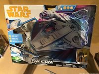 Front view of unopened Star Wars Kessel Run Edition Millennium Falcon toy box showing ship and included character figure.