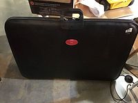 Full view of large black vinyl art portfolio carry case showing rectangular shape and handle.