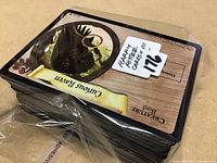 Photo of stack of Harry Potter trading cards showing a Curious Raven card on top, with a lot number sticker.