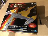 Front view of the factory sealed Star Wars Naboo Fighter electronic toy box showing the ship and branding