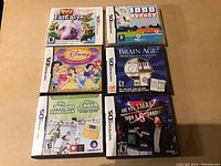Clear photo showing six Nintendo DS game cases with cover art and booklets.