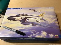 Box cover of the Hasegawa F-4J Phantom II model kit showing the aircraft illustration and brand logo.