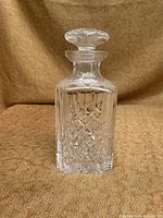 Front view of the heavy crystal decanter showing geometric cut pattern and stopper