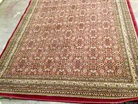 Full view of Persian style carpet showing overall pattern and borders.