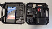 Cordless drill, battery, charger, multiple drill and screwdriver bits in black carrying case