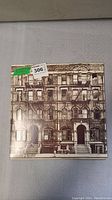 Front cover of the Led Zeppelin Physical Graffiti album showing sepia photograph of a brownstone apartment building.