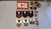 Lot of assorted military and Boy Scout patches with one flag-type patch, including USS Kitty Hawk patch and Department of Defense Pentagon patch.