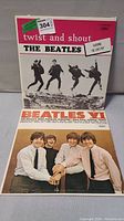 Front view of both Beatles LP albums, Twist and Shout and Beatles VI showing album covers and condition.