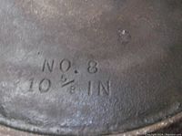 Close-up photo showing the No. 8 and 10 1/2 inch size markings on cast iron skillet
