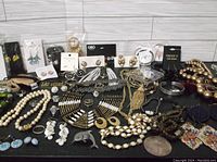 Wide view of assorted costume jewelry, including necklaces, bracelets, rings, and earrings in various styles and colors.