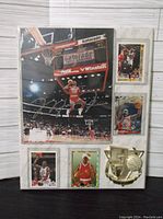 Full view of framed display showing signed reprint photo and five Michael Jordan basketball cards arranged around it