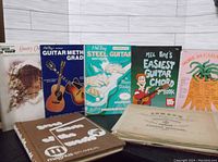 Overview of six music books and stack of vintage sheet music packed for pickup, showing cover titles and condition.