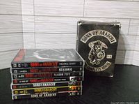 Photo showing all seven season DVD cases stacked next to the original series box that shows signs of wear