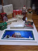 Photo of all holiday decor items together including stained glass picture and boxed ornaments