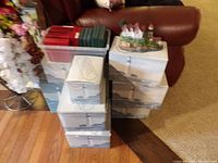 Stacked original Harbour Lights lighthouse collectible boxes with an unboxed lighthouse figurine model on top