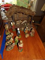 Full view of nativity set arranged on table with stable and all figurines