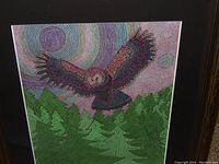 Full view of the colorful owl print with forest and circular pattern background.