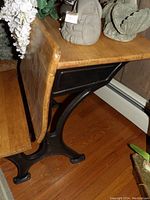 Side view showing the wooden foldable desk top and black metal support frame.