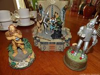 Overview of Wizard of Oz figurines including Lion, Tin Man, and a castle display with Dorothy, Scarecrow, Witch.