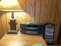 Overview of lion head lamp on left, Bose CD player stack in center, CD rack on right