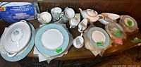Overview of service pieces including plates, tureen, gravy boat, sugar bowl, and creamer